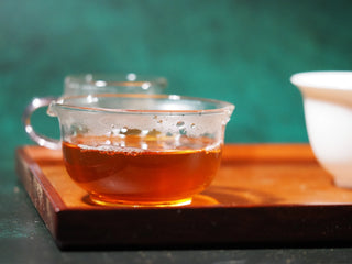 Complete traditional tea setup showing the clear liquor of YXT Jingyang Golden Flower Fu Tea First Grade 300g in a glass mug.