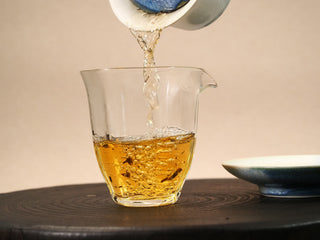 First steep of 2020 Fuding White Peony poured into a glass pitcher, the liquor a clear pale golden yellow color.