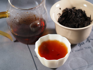 A professional Gongfu tea set featuring the 2013 aged Hei Cha liquor, a pitcher, and a traditional tasting cup.
