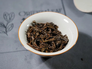 Close-up of opened gaiwan showing wet leaves of the Sticky Rice Aroma Raw Pu-erh Cake 2013 200g