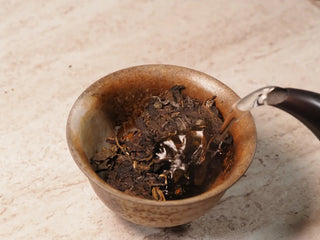 Hot water being poured into gaiwan over Value Classic 2008 Tribute Sheng Pu-erh Tea Cake – 357g Menghai (2019 Pressed) during brewing