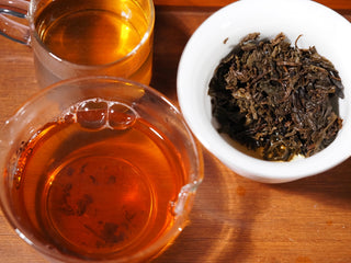 Wet, fully hydrated leaves (spent grounds) of YXT Jingyang Golden Flower Fu Tea First Grade 300g, showcasing leaf quality.