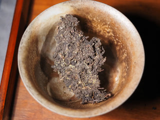 Dry YXT Jingyang Fu Tea Ximanzi 2018 crumbles placed in a white bowl, ready for the initial wash and brewing.