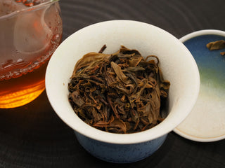 Brewed tea leaves of 2019 Dayi 8542 raw puerh displayed in a gaiwan