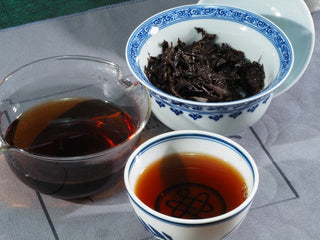 A beautiful Puerh-style tasting set featuring the 2015 Fu Brick tea liquor and traditional tea wares.
