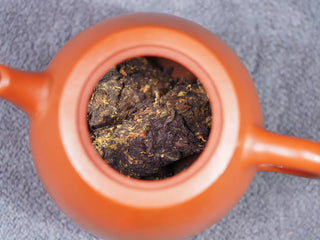 Steeping the 1958 Fu Brick tea inside a traditional purple clay Yixing teapot.