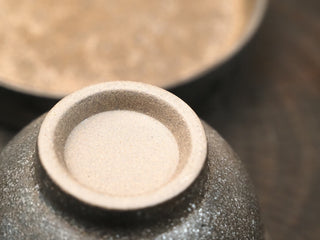 Top of wood-fired stoneware gaiwan lid from Dehua Fujian, inverted to show the foot ring and impressed marking on the knob.