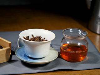 Yiwu Raw Pu-erh Cake – 2013 Spring Tea, Hand-Pressed 2023, Sweet & Layered (100g) tea setup with brewed tea liquor, wet leaves in gaiwan, and poured tea in gongdaobei, showcasing complete tea experience