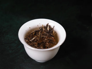 Yunnan Jinggu White Peony Tea Cake 357g fully steeped in gaiwan, showing bright yellow, silky liquor