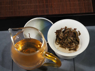 Fully brewed Yunnan Raw Pu-erh Waffle Cake – Three Legendary Leaves showing wet leaves and tea liquor in gongdao cup