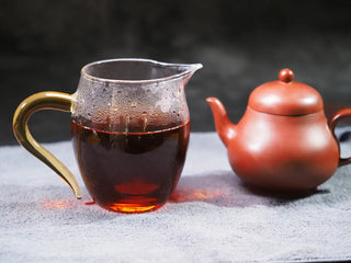 Bright amber tea liquor of Golden Flower Fu Brick Tea with a traditional teapot.