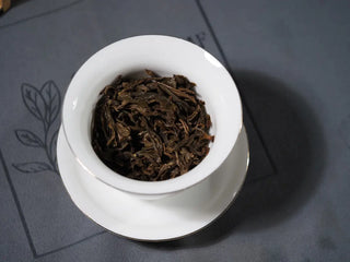 Second infusion leaves of 2018 Dazhai Ancient Tree Raw Pu-erh Tea Cake in gaiwan, showing yellow bright leaf bottom