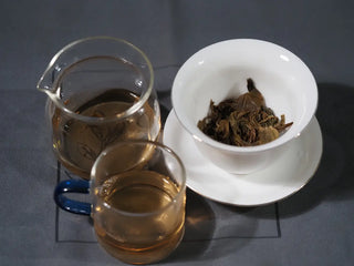 Complete tea setup with Mengku TeaSoul Sheng Pu-erh Coin Tea in gaiwan, gongdao cup, and small tasting cups