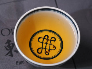 Close-up of brewed tea liquor from Yunnan High Mountain Wild Ancient Tree Shoumei White Tea (2019) in a tasting cup