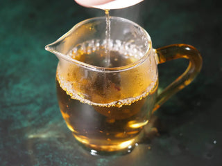 Tea liquor from Yunnan Jinggu White Peony Tea Cake 357g poured into a Gongdao cup, highlighting clarity and color