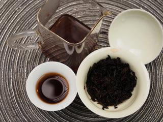 Complete brewing setup with 2018 Dayi V93 ripe puerh tea liquor and steeped leaves