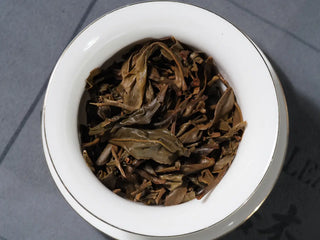 Fifth infusion leaves of 2018 Dazhai Ancient Tree Raw Pu-erh Tea Cake in gaiwan, highlighting uniform bright leaves