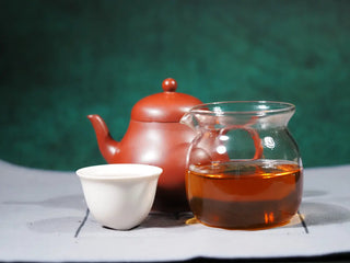Complete tea setup with Jingyang Golden Flower Fu Brick Tea, purple clay teapot, Gongdao cup, and small tea cups arranged together for traditional dark tea brewing.