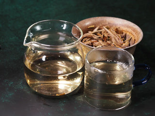 Gaiwan with infused leaves, fair cup, and tasting cup side-by-side showing bright liquor of 2023 Jinggu Silver Needle White Tea
