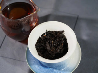 Wet leaves of On Taoism Golden Flower Fubrick inside a brewing gaiwan, ready for re-infusion.