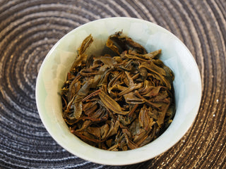 Macro view showing the uniform size and tender structure of infused 2025 Tan Chun raw Puerh tea leaves.