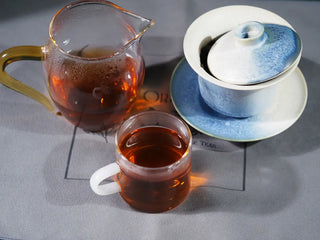 Full serving set of On Taoism (Jingtai Hao) Fucha, including the brewed tea and the elegant brewing vessel.