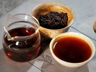 Gaiwan, gongdao cup, and tasting cup arranged together, displaying complete Bulang Mountain Ancient Tree Ripe Pu-erh tea setup