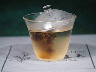 Refreshing iced Golden Flower White Tea drink with condensation and ice, perfect for summer.