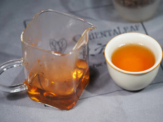 Perfectly brewed Golden Flower White Tea (Fuding origin) served in a small cup, ready for tasting.