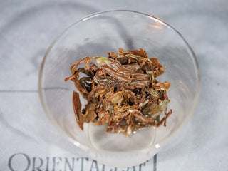 Detailed view of the brewed leaves and mini-cake remnants of the Golden Flower White Tea, showing the quality of the Fuding material.