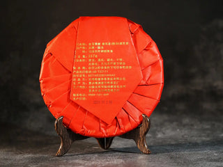 Golden Treasure Ripe Puerh Tea Cake – Menghai Origin, back view of the tea cake packaging, featuring traditional Chinese design elements and detailed product information.