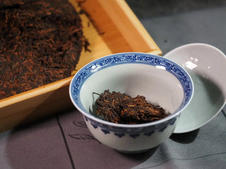 Misty Gold Bud Ripe Pu-erh Tea Cake – Menghai First-Spring-small piece of tea placed in a gaiwan, showcasing the texture and golden buds before brewing
