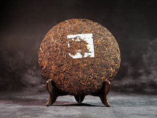 Misty Gold Bud Ripe Pu-erh Tea Cake – Menghai First-Spring-front view of the tea cake fully unwrapped, showcasing dense golden buds on the surface