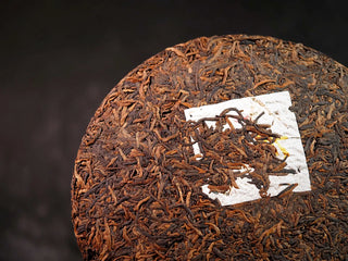 Misty Gold Bud Ripe Pu-erh Tea Cake – Menghai First-Spring-close-up detail of the tea cake’s front surface, highlighting plump golden buds