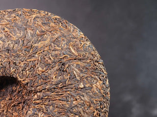 Misty Gold Bud Ripe Pu-erh Tea Cake – Menghai First-Spring-back detail of the tea cake highlighting another section with dense golden buds