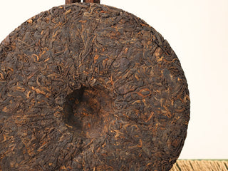 Close-up of the center of a Jing Chang Hao Deep Velvet 2020 ripe Pu-erh cake, tightly compressed dark tea leaves