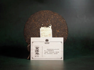 Unwrapped 2018 Ancient Grove Pu-erh Tea Cake displayed with the product information card