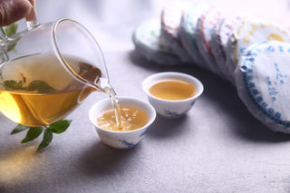 Pouring Golden Yunnan Lincang Raw Pu-erh Tea Liquor into Cups Brewing Process