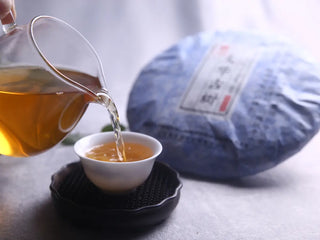 Taihua Ancient Tree Raw Puerh 2016 Gushu Sheng Cake in paper wrap, side view, aged raw puerh tea