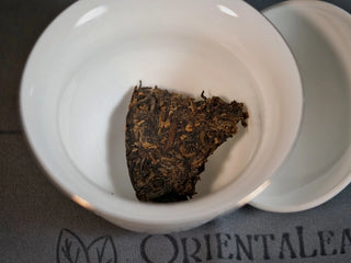 Chang'an Golden Flower Fu Brick Tea Mini Cake – 60g small piece broken off and placed in gaiwan