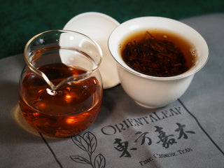 Chang'an Golden Flower Fu Brick Tea Mini Cake – 60g brewed tea in gaiwan with leaves and amber liquor in fair cup