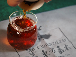 Chang'an Golden Flower Fu Brick Tea Mini Cake – 60g pouring brewed tea from gaiwan into glass fair cup