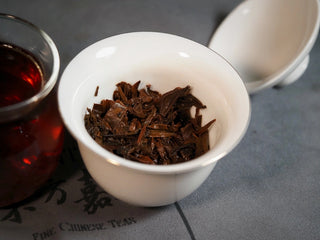 Chang'an Golden Flower Fu Brick Tea Mini Cake – 60g close-up of brewed leaves showing uniform, soft, reddish-brown leaf base