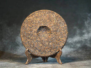 Back view of Classic 1973 Large 400g Ripe Pu-erh Tea Cake Menghai after unwrapping, showing leaf compression