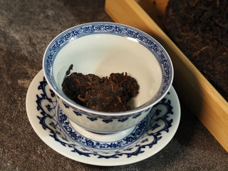Loose leaves of Classic 1973 Large 400g Ripe Pu-erh Tea Cake Menghai in a gaiwan ready for brewing