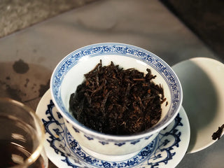 Wet leaves (leaf base) of Classic 1973 Large 400g Ripe Pu-erh Tea Cake Menghai after brewing, showing plump, whole leaves