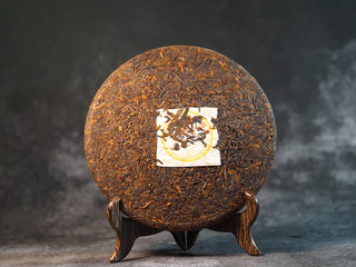Front view of Classic 1973 Large 400g Ripe Pu-erh Tea Cake Menghai after unwrapping, showing compressed tea surface