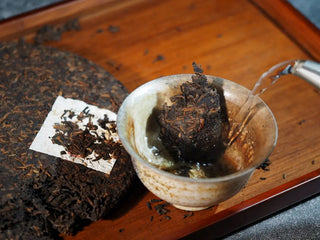 Mixiang 2017 Ripe Pu-erh Tea – MengHai Mid-Aged Golden Tip Pu-erh being infused with hot water in a gaiwan, capturing the moment of brewing