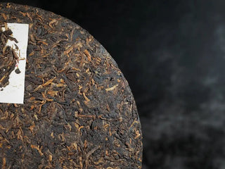 Mixiang 2017 Ripe Pu-erh Tea – MengHai Mid-Aged Golden Tip Pu-erh detailed close-up of the tea cake surface, showcasing the rich texture and prominent golden tips