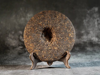 Mixiang 2017 Ripe Pu-erh Tea – MengHai Mid-Aged Golden Tip Pu-erh back view of the unpackaged tea cake, showing a beautiful surface with golden buds and dark brown leaves